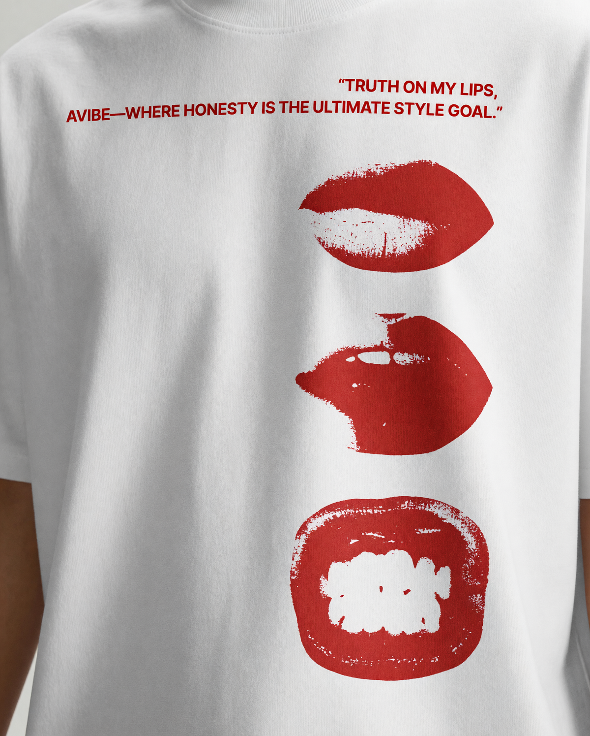 White short-sleeve T-shirt with red printed text and three red lip graphic prints on the front.
